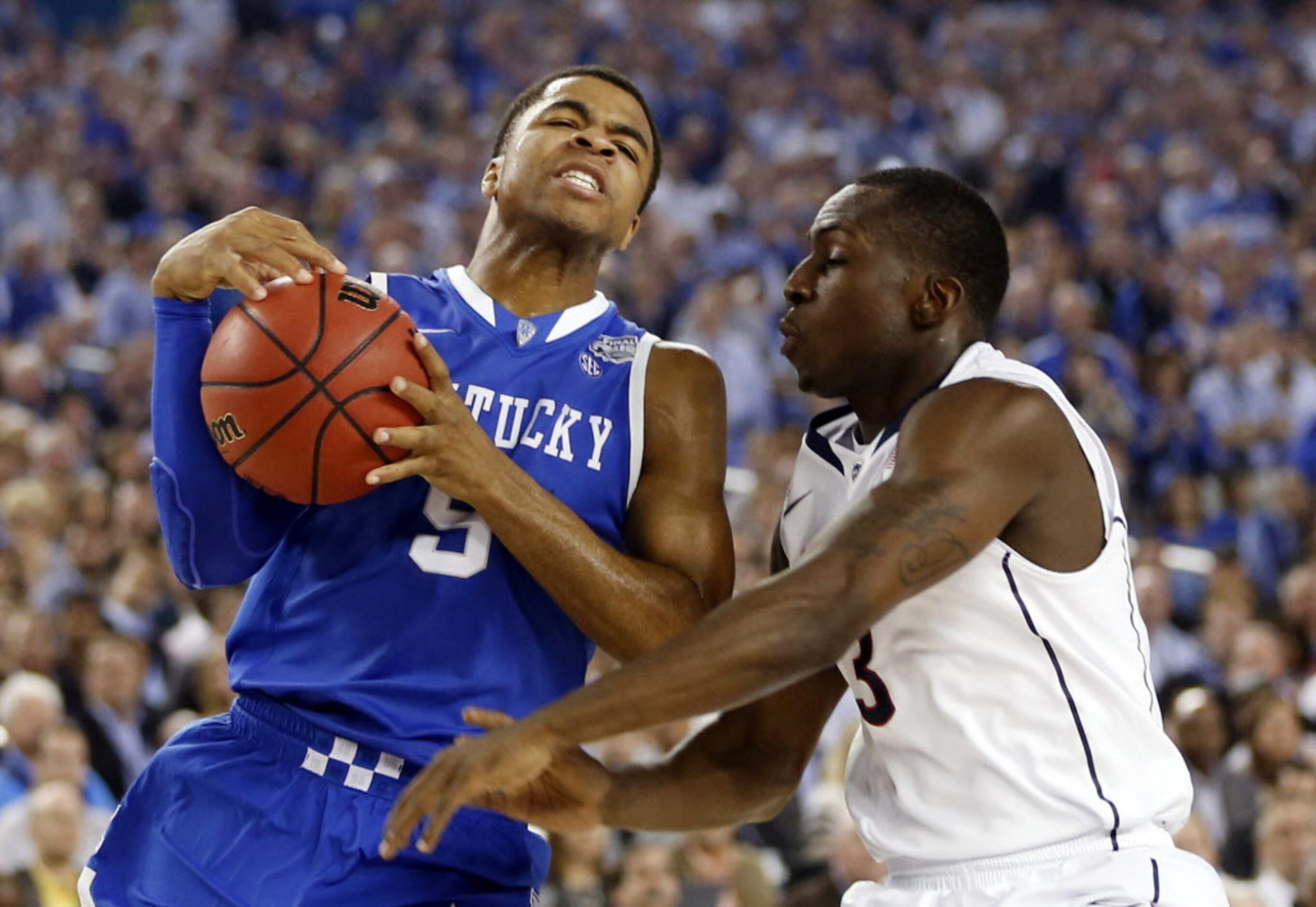 Kentucky Wildcats guard Andrew Harrison (5) drives against Connecticut Huskies guard...