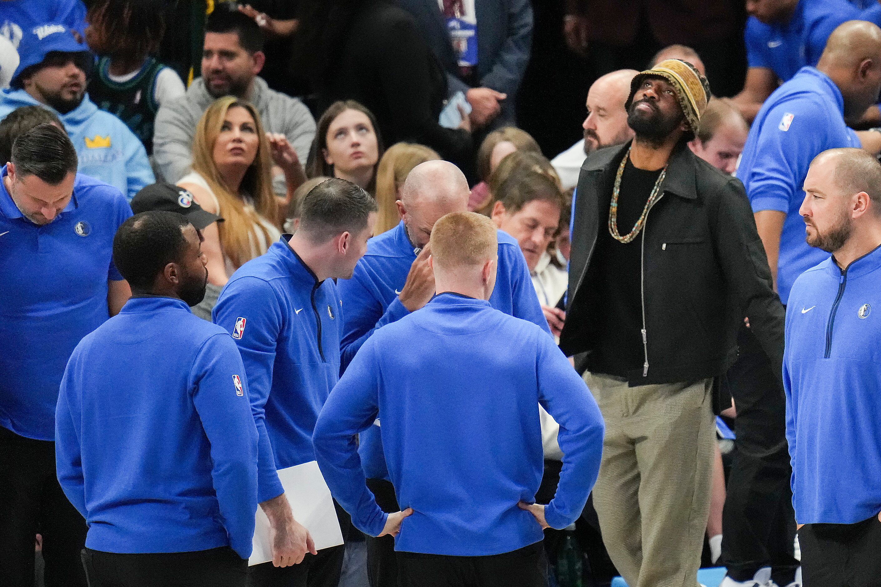 Dallas Mavericks guard Kyrie Irving (wearing knit cap) looks up during a timeout in the...