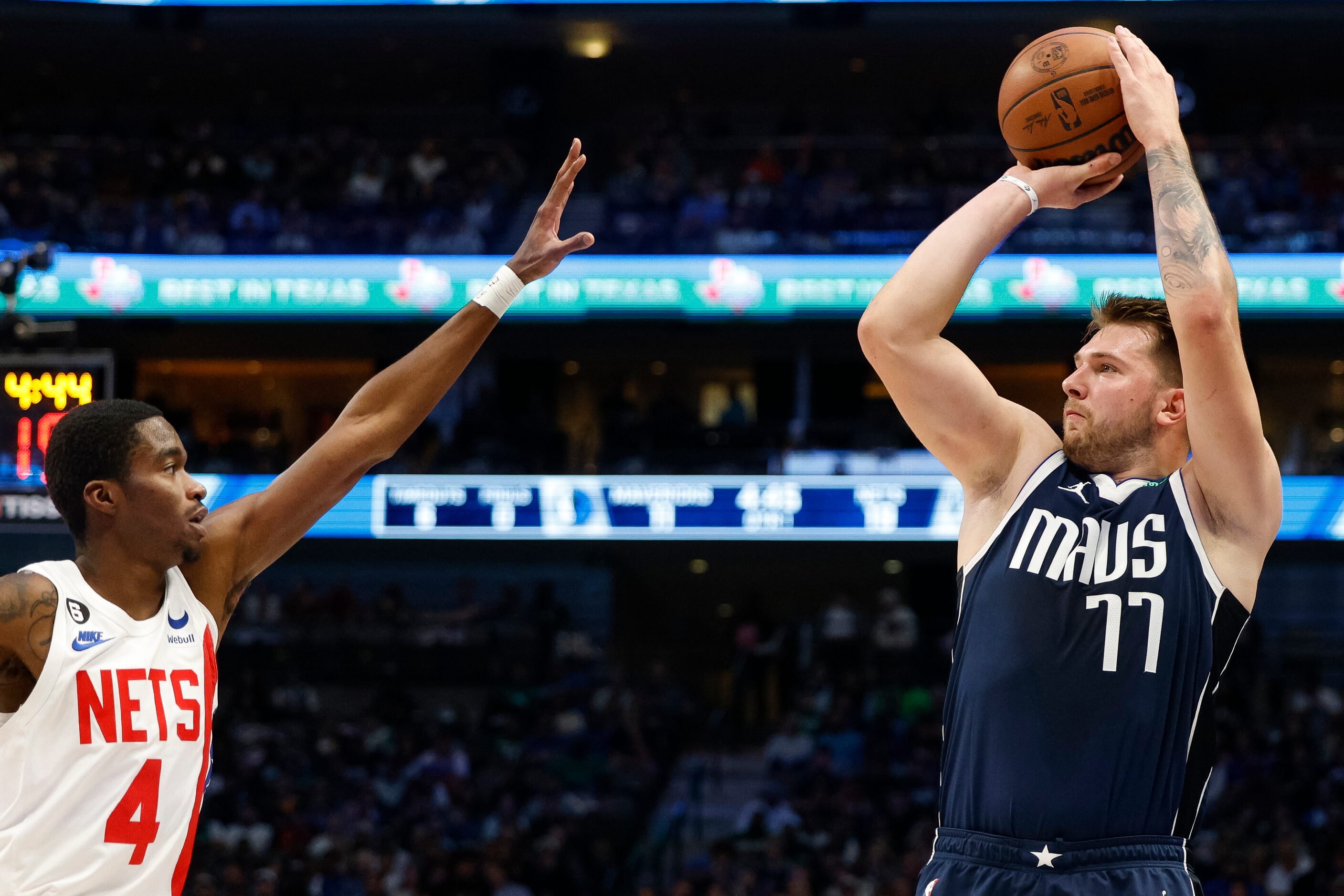 Dallas Mavericks guard Luka Doncic (77) attempts a three-point shot over Brooklyn Nets guard...