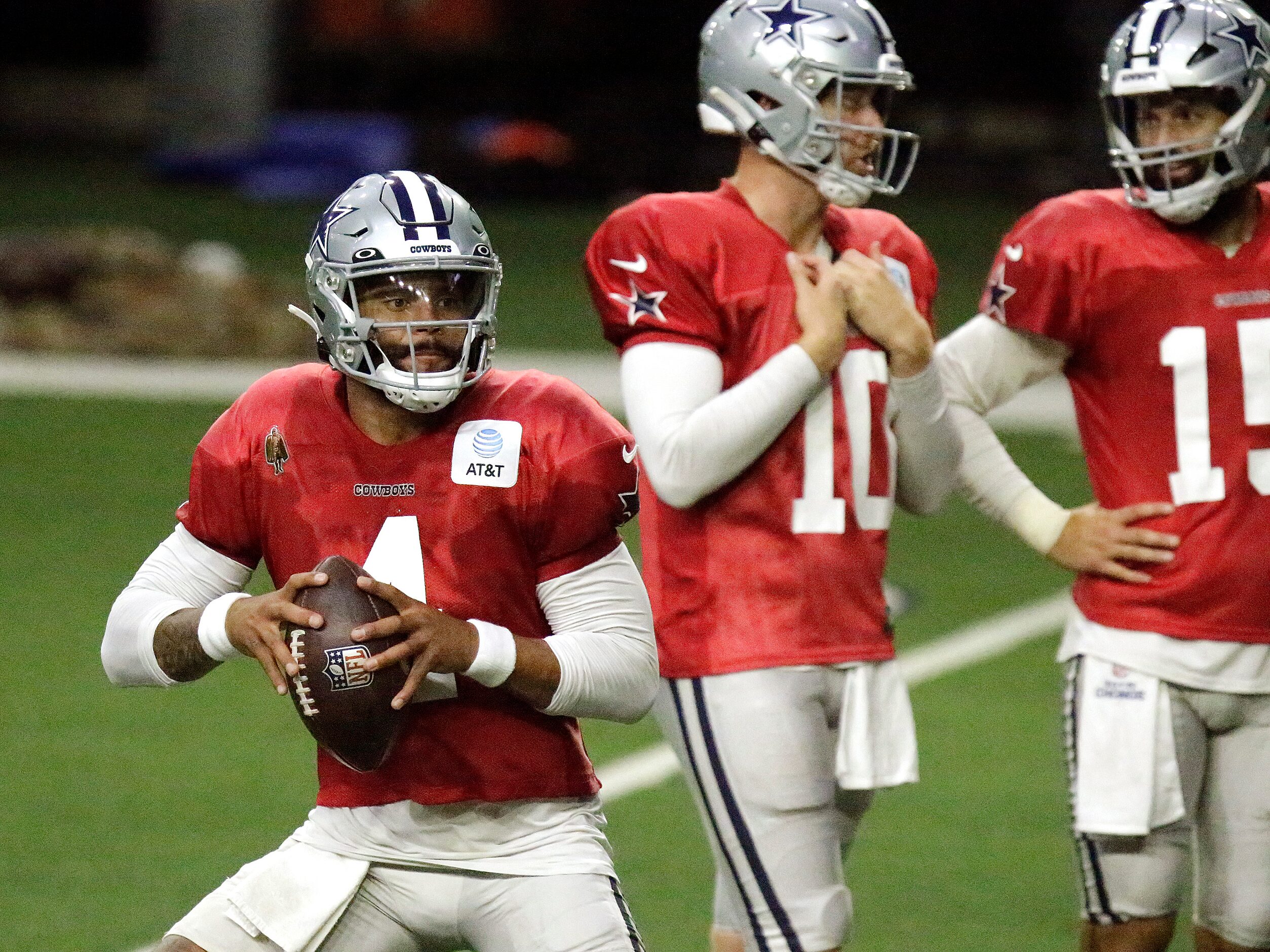 Dallas Cowboys quarterback Dak Prescott (4) drops back during a drill as the Dallas Cowboys...