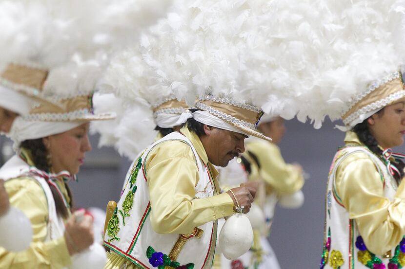 Juanito Gress, center, and his fellow Matachines perform a dance in honor of the La Virgen...