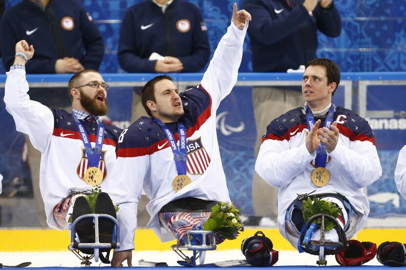 United States players Taylor Lipsett, left, Greg Shaw, center, and Andy Yohe celebrate after...