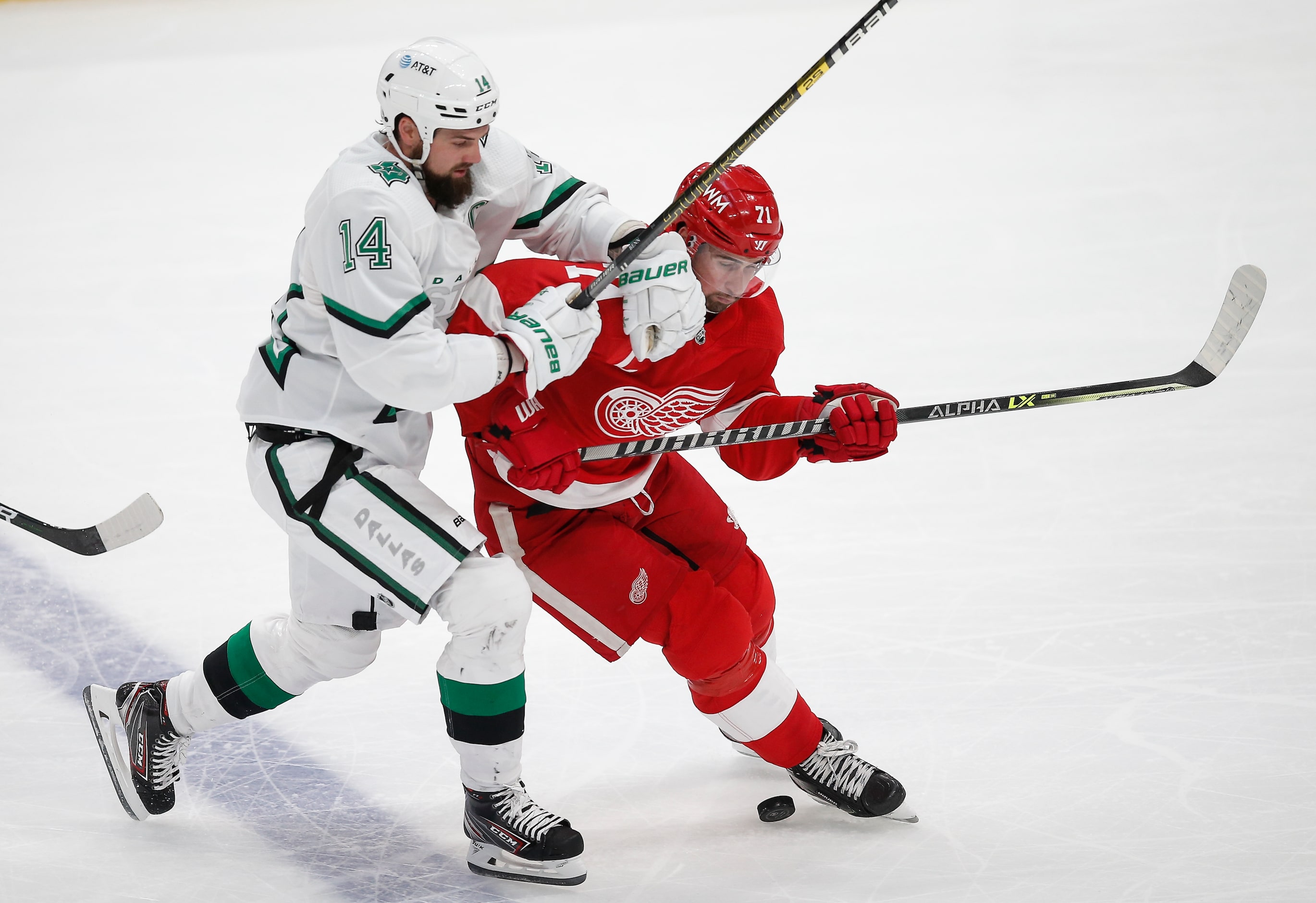 Dallas Stars forward Jamie Benn (14) battles Detroit Red Wings forward Dylan Larkin (71) for...