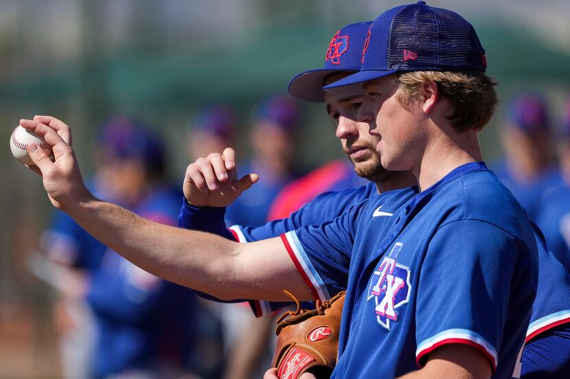 Pitcher TK Roby (front) talks with fellow pitcher Jackson Leath during a Texas Rangers minor...