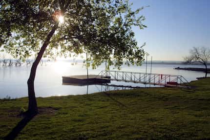 April 9, 2003 - The early morning sun shines thru a tree near a small dock in Lynn Creek...