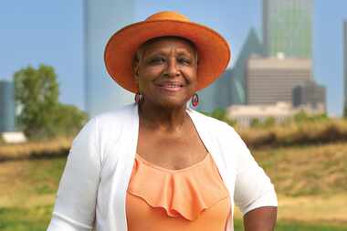 Vicki Meek standing in front of Dallas skyline.