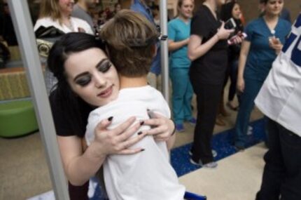  WWE Diva Paige hugs scoliosis patient JohnMichael Mormon at Texas Scottish Rite Hospital...