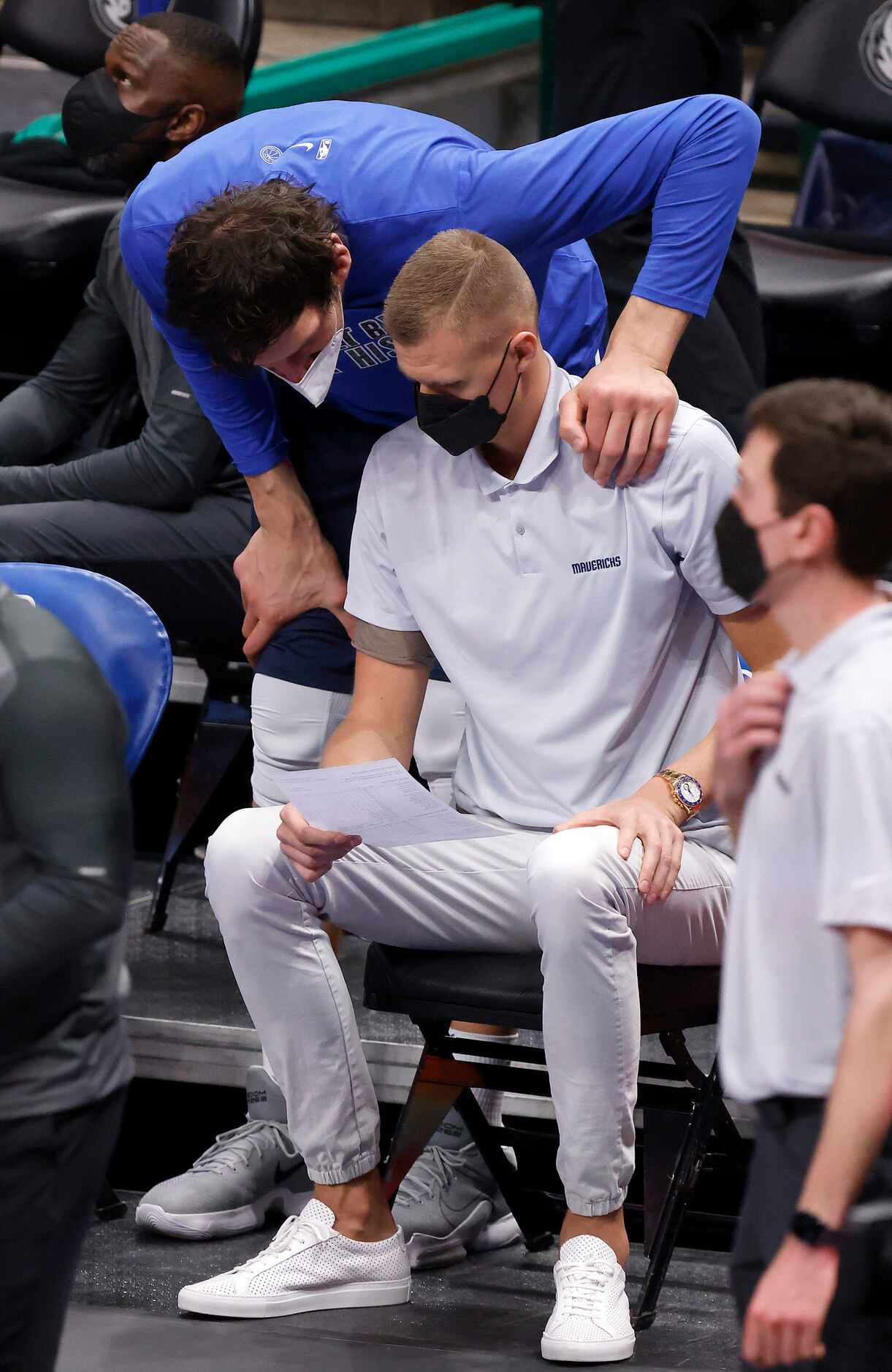 Dallas Mavericks center Boban Marjanovic (51) looks over injured center Kristaps Porzingis'...