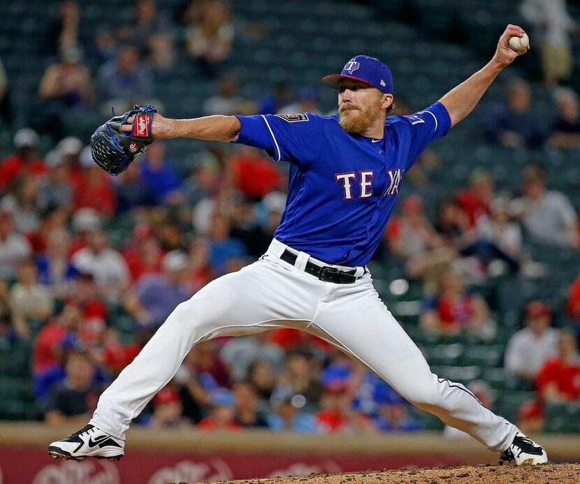 Texas Rangers relief pitcher Jake Diekman throws a pitch against Cincinnati Reds during the...