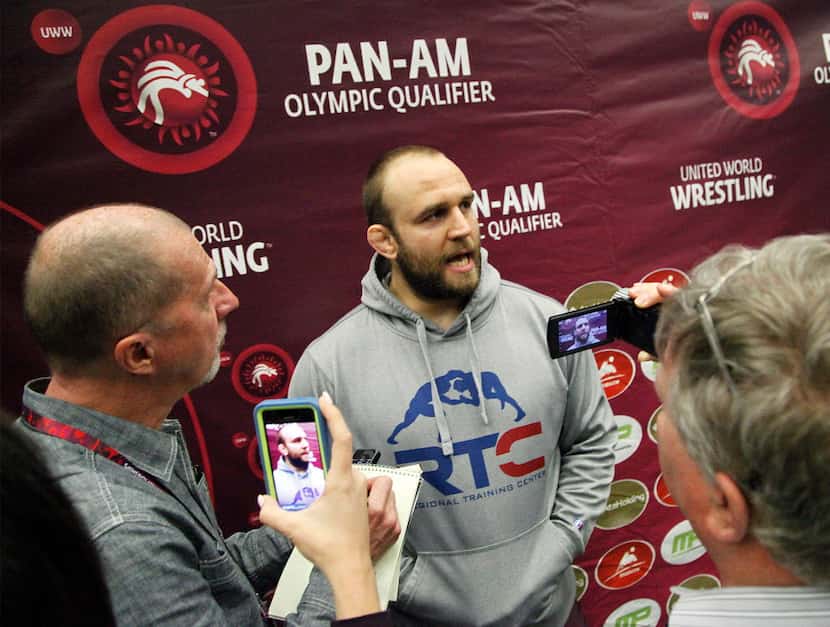 Tervel Dlagnev of the USA wrestling team, answers questions for the media after he won his...