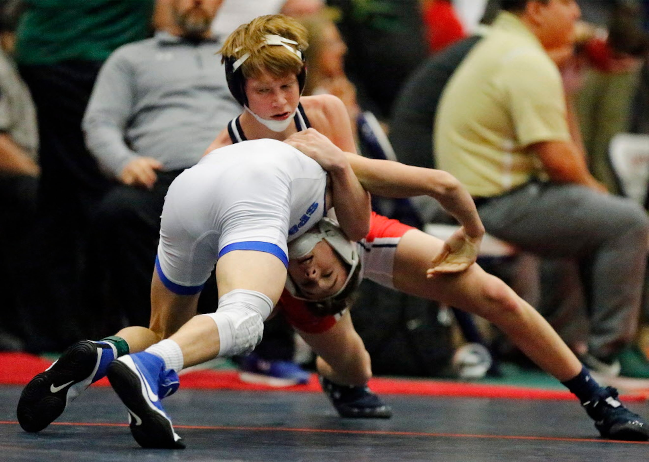 Tyten Volk (top) of Frisco Centennial High School competes with Wesley Goleman of Burleson...