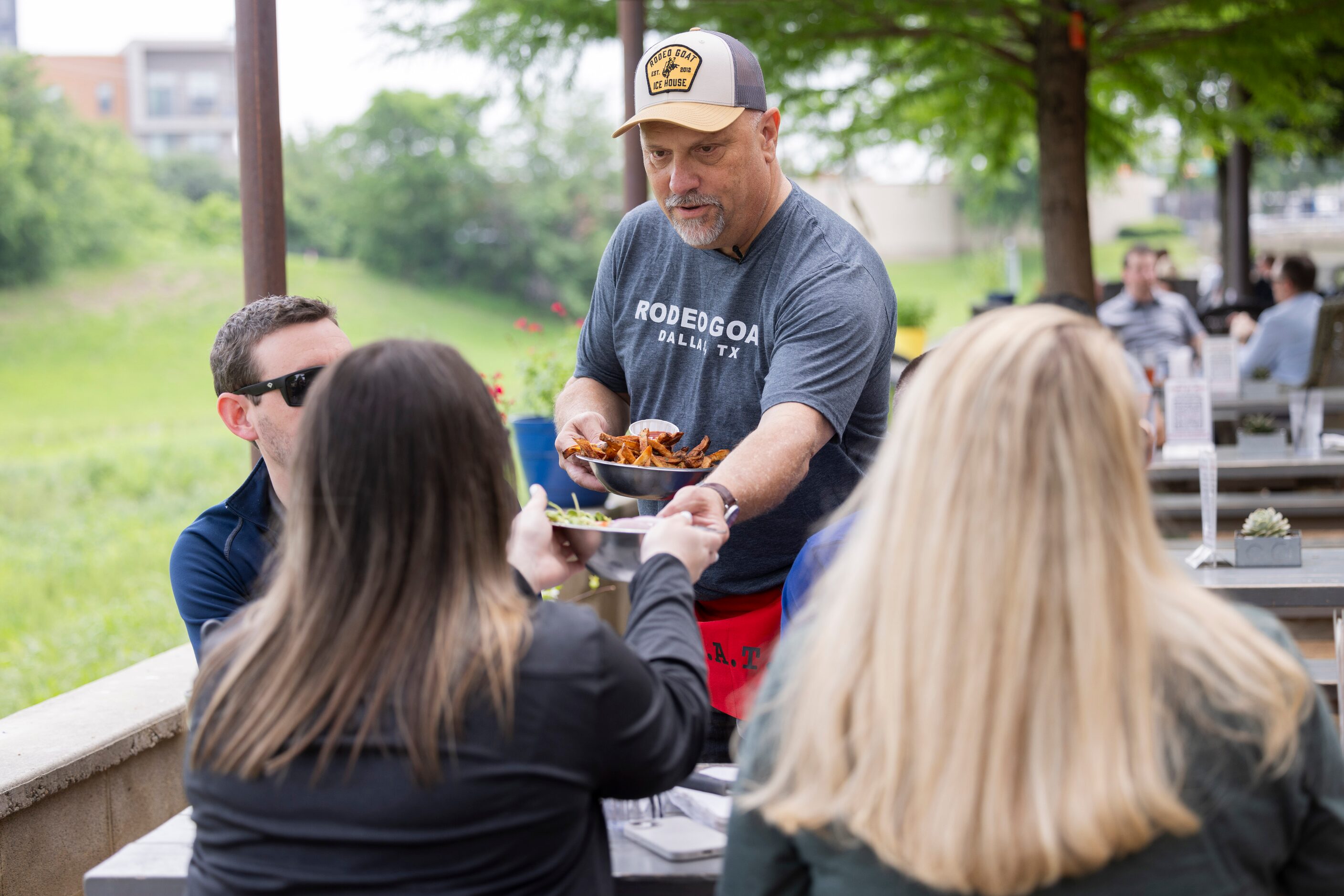 The Dallas Morning News’ Rangers reporter delivers food to a table as he "works a shift"...