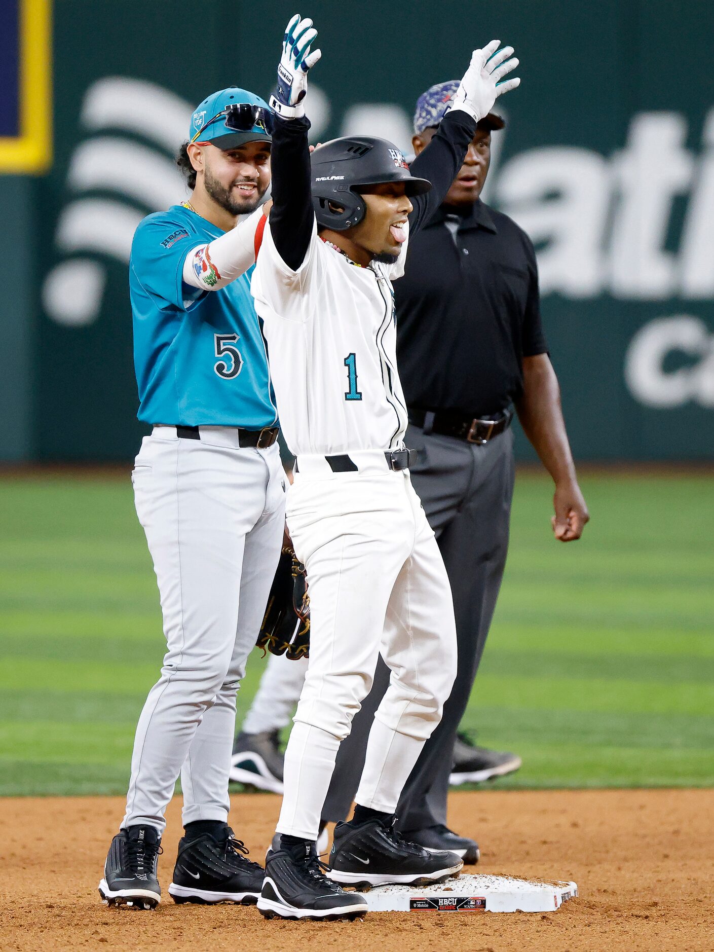 American League batter Tiger Borom (1) swings his hips as his Grambling State teammate Jose...