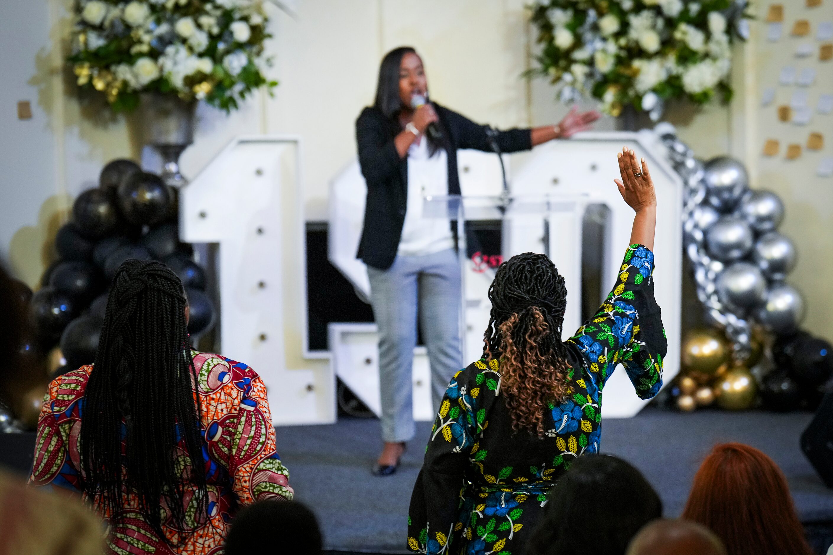 Senior pastor Lucretia Facen raises her hand as Rev. Tiffany Tarrant, senior pastor of St....