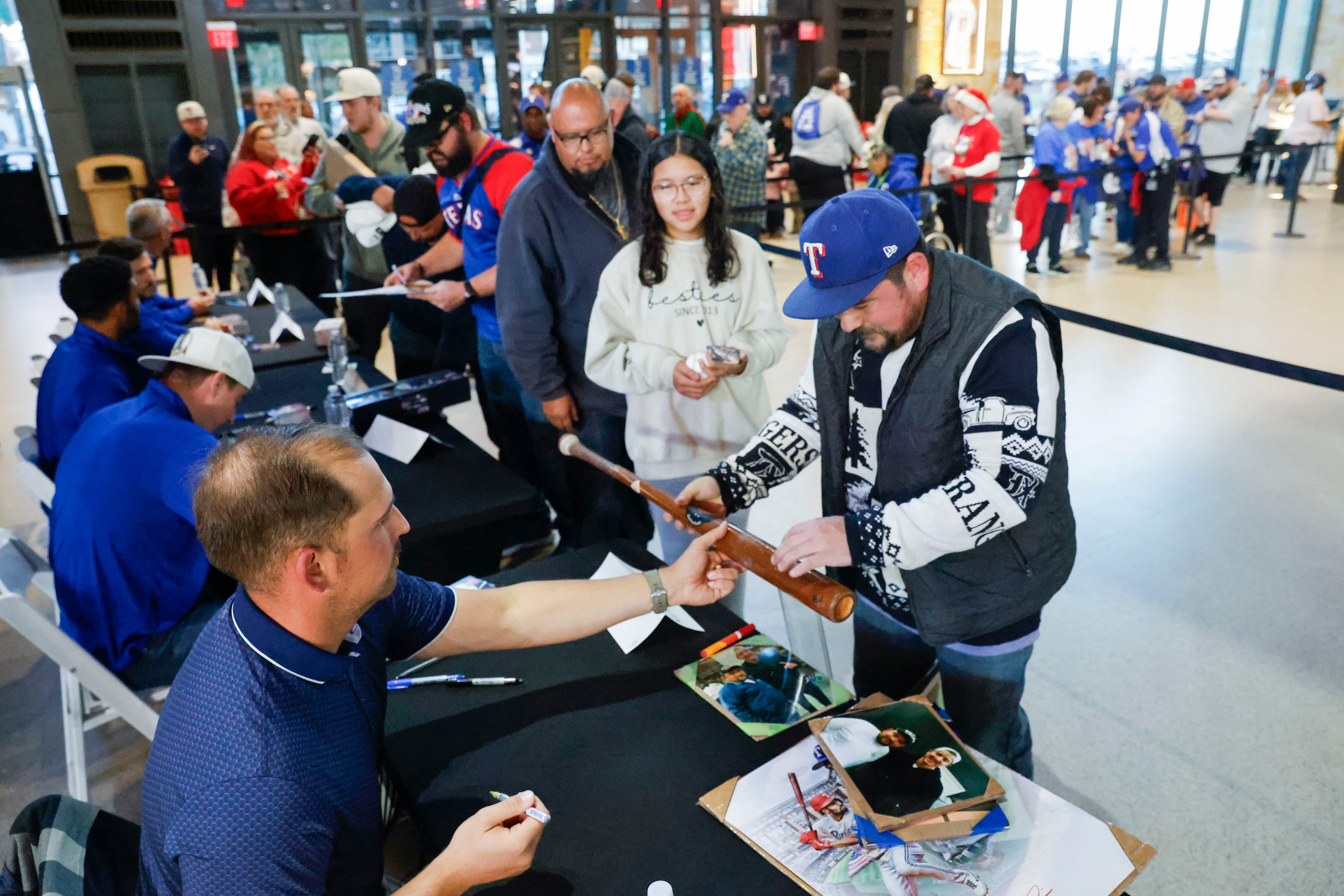 Texas Rangers second baseman Marcus Semien interacts with fans while signing autographs...