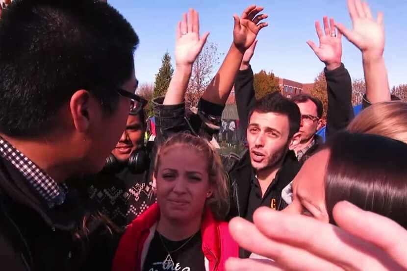 Student protesters try to block a newspaper photographer from covering a campus rally...