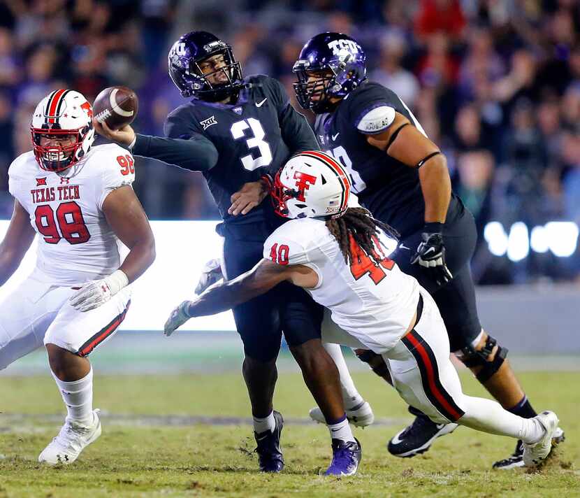 TCU Horned Frogs quarterback Shawn Robinson (3) throws a desperation pass as he's hit by...
