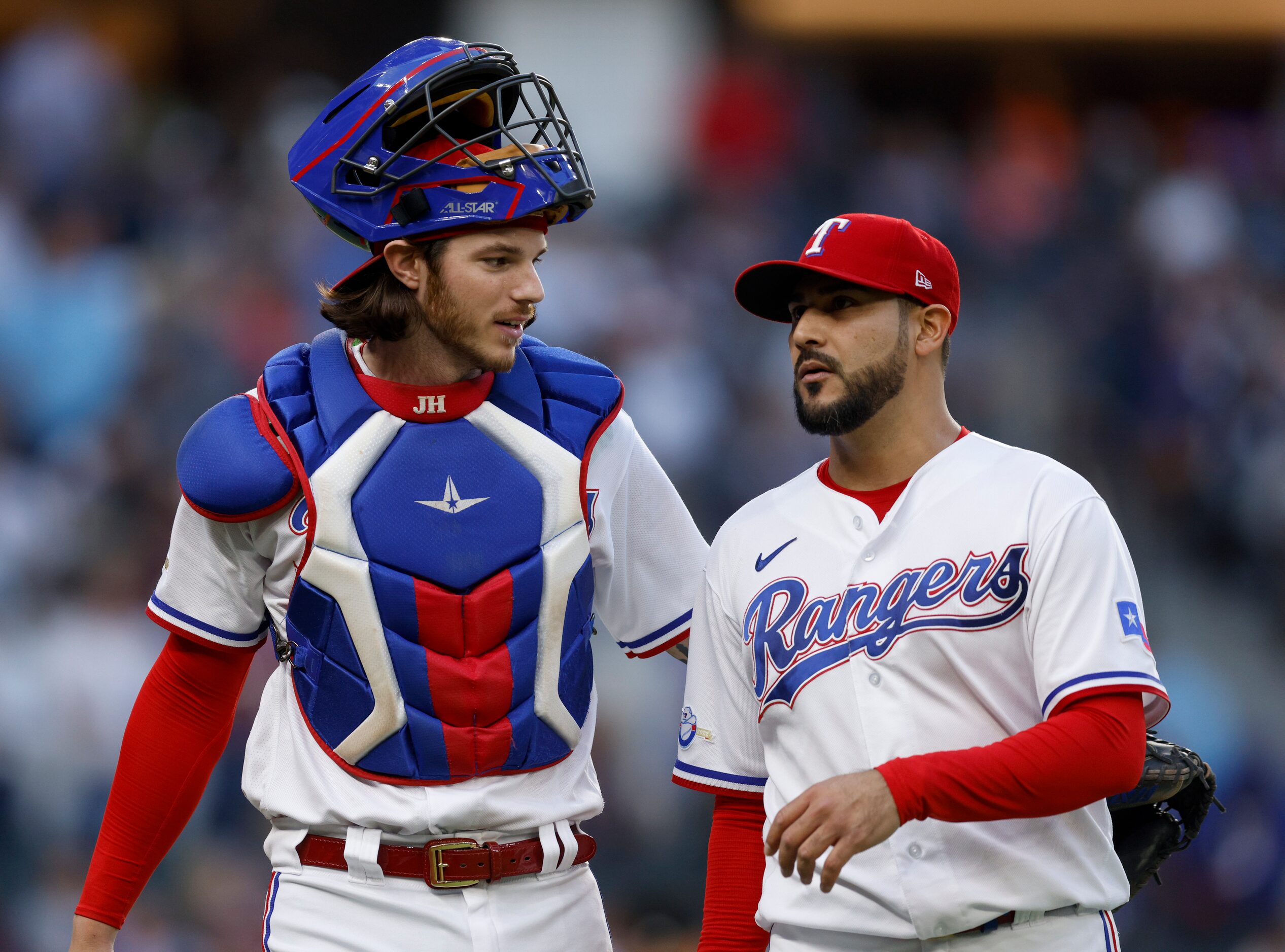 Texas Rangers starting pitcher Martin Perez (right) talks with catcher Jonah Heim (28)...