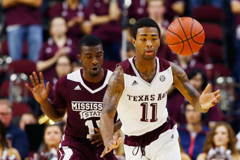 COLLEGE STATION, TX - FEBRUARY 24:  Anthony Collins #11 of the Texas A&M Aggies battles for...