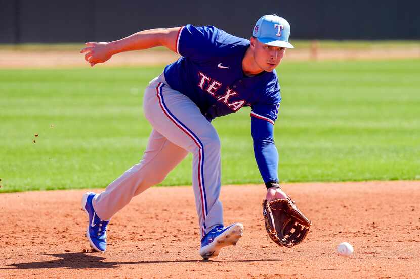 Texas Rangers infielder Justin Foscue participates in a fielding drill during the first full...