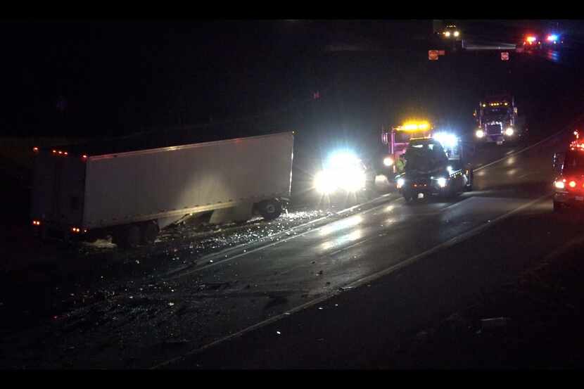 An 18-wheeler rests along the side of State Highway 287 in Rhome after it struck a guardrail...