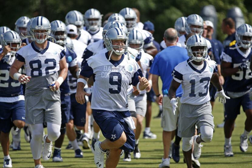 Dallas Cowboys quarterback Tony Romo (9) leads the team during a warm-up at the team's last...