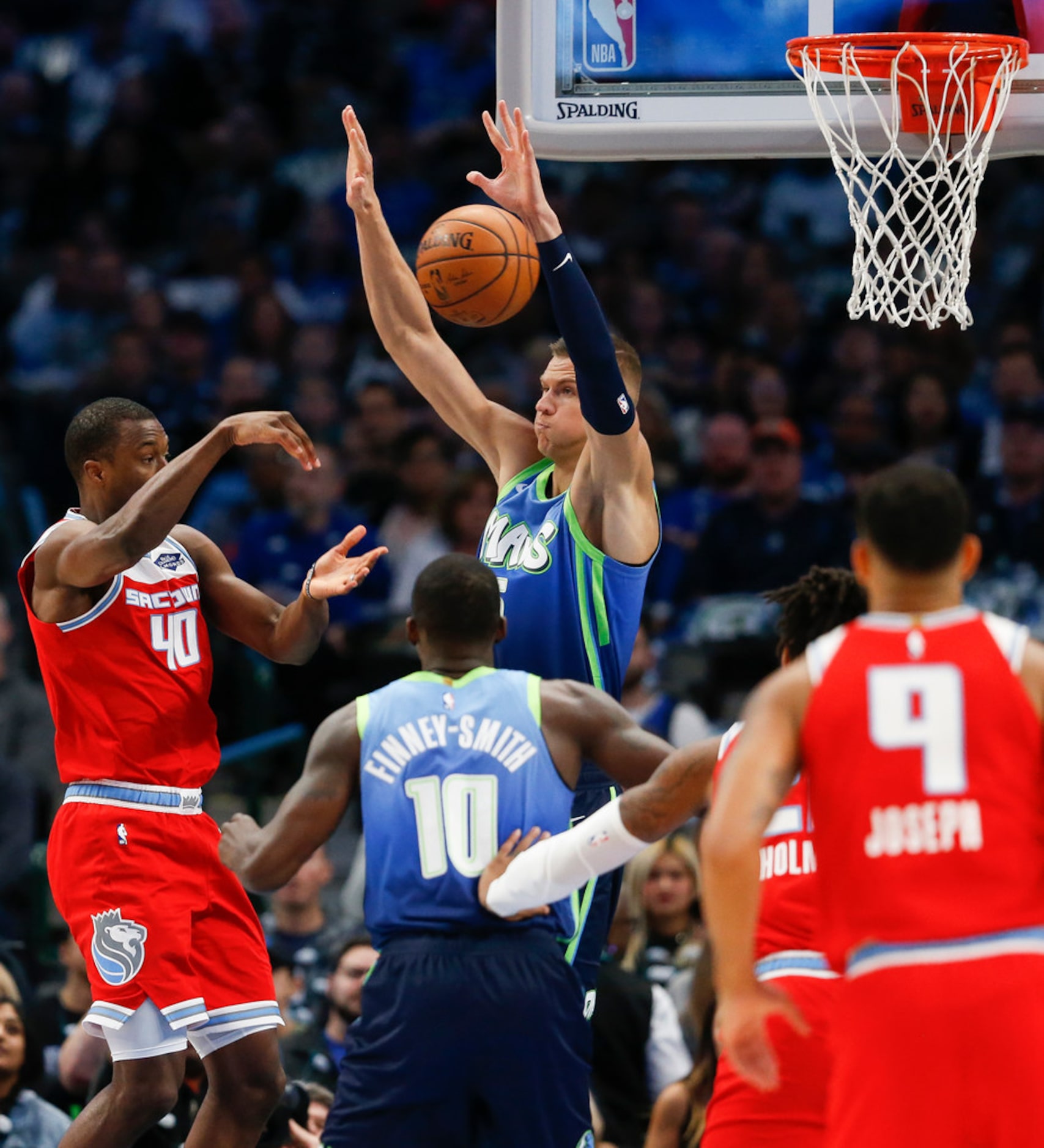 Dallas Mavericks forward Kristaps Porzingis (6) jumps to guard Sacramento Kings forward...