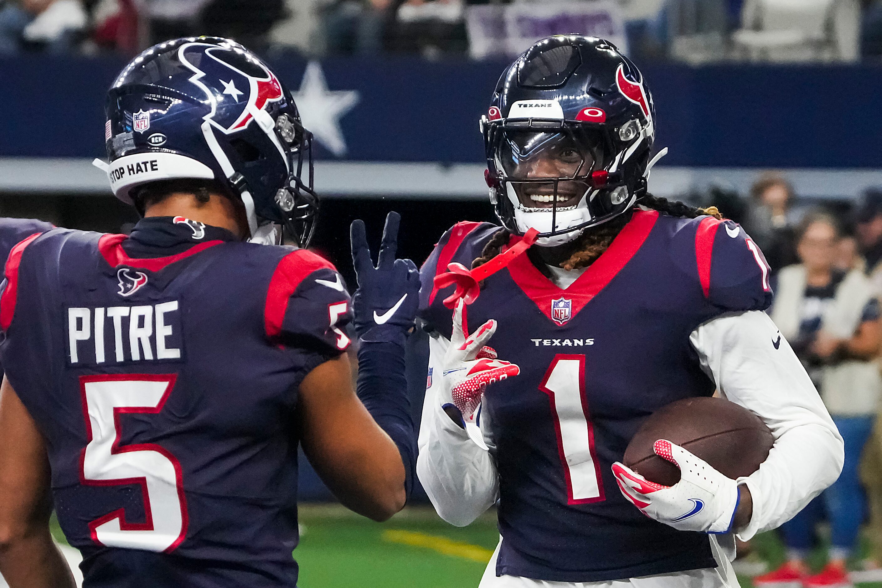 Houston Texans cornerback Tremon Smith (1) celebrates with safety Jalen Pitre (5) after...