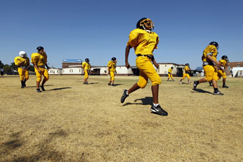 Members of the W.E. Greiner middle-school football team, made up of 7th and 8th-graders, ran...