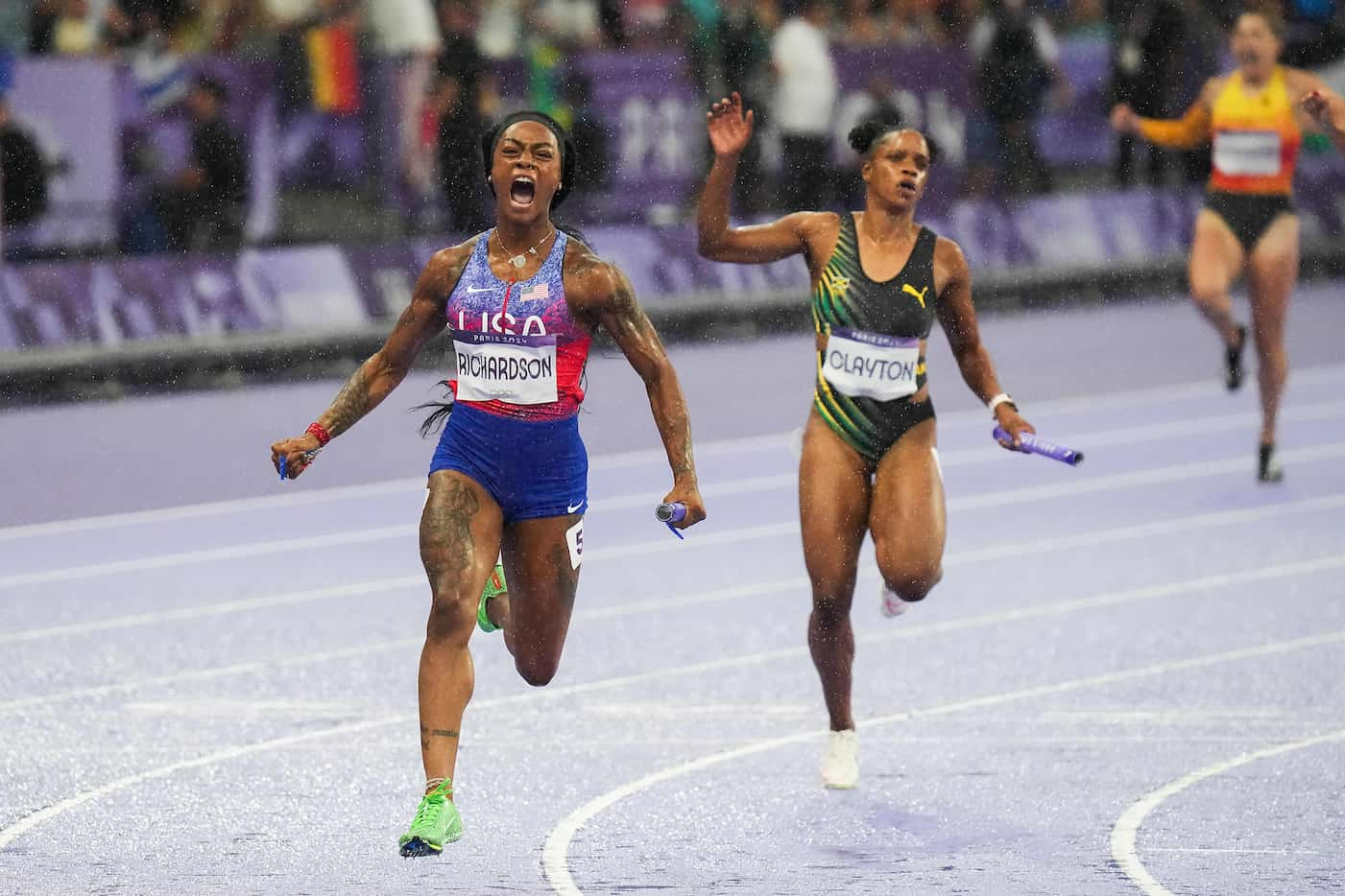 Sha'Carri Richardson of the United States crosses the finish line to win the women's 4 x 100...