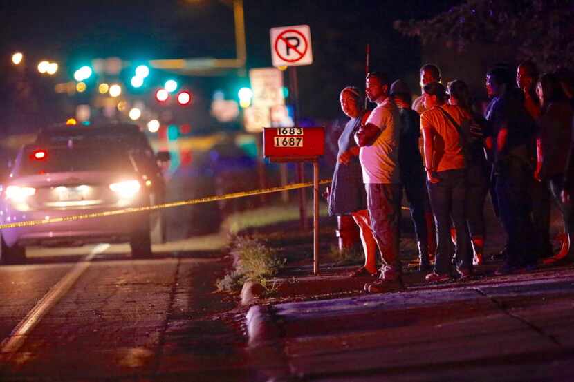 A crowd gathers where a police officer shot a man in a car Wednesday in Falcon Heights, Minn.