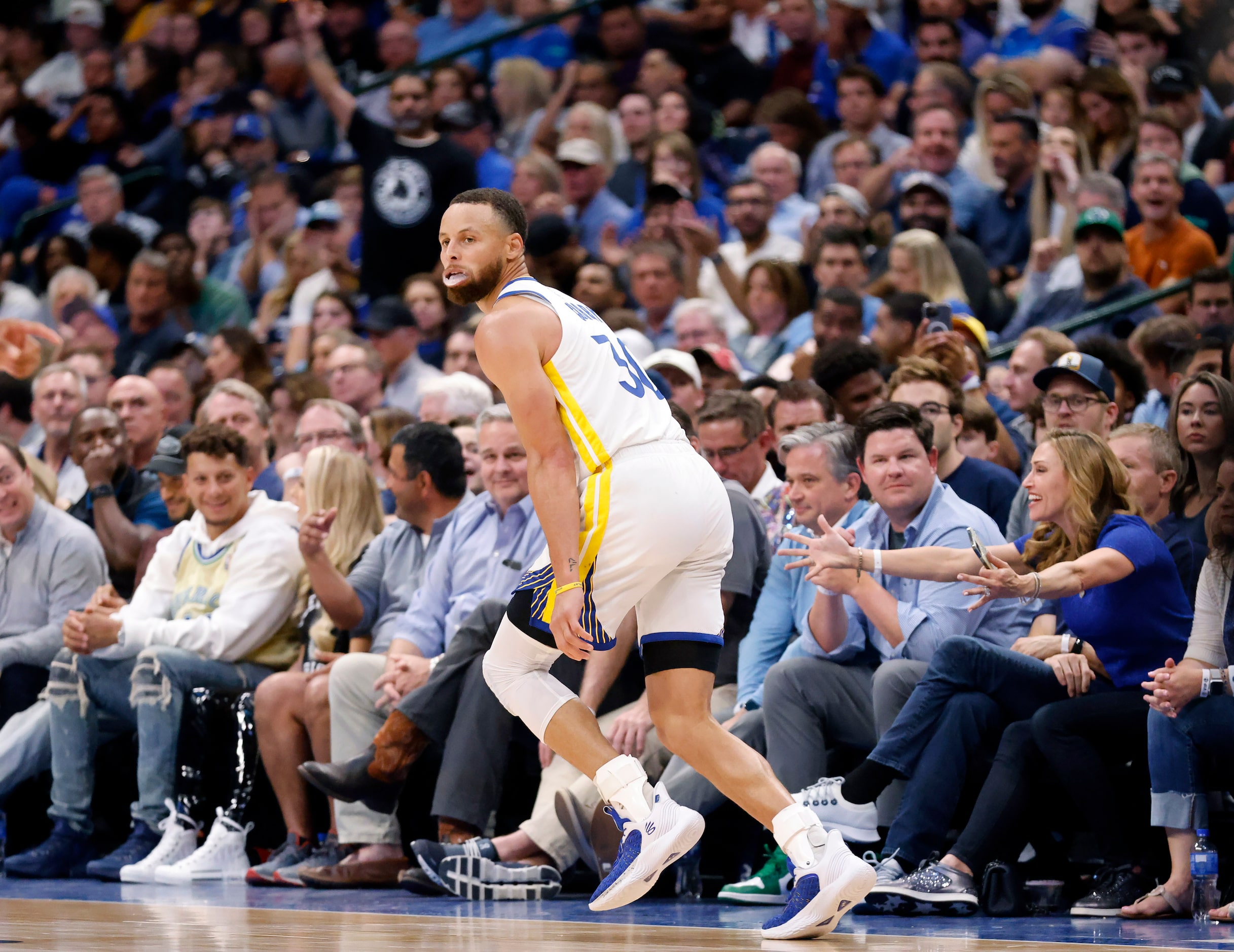 Golden State Warriors guard Stephen Curry (30) races down the court and celebrates second...