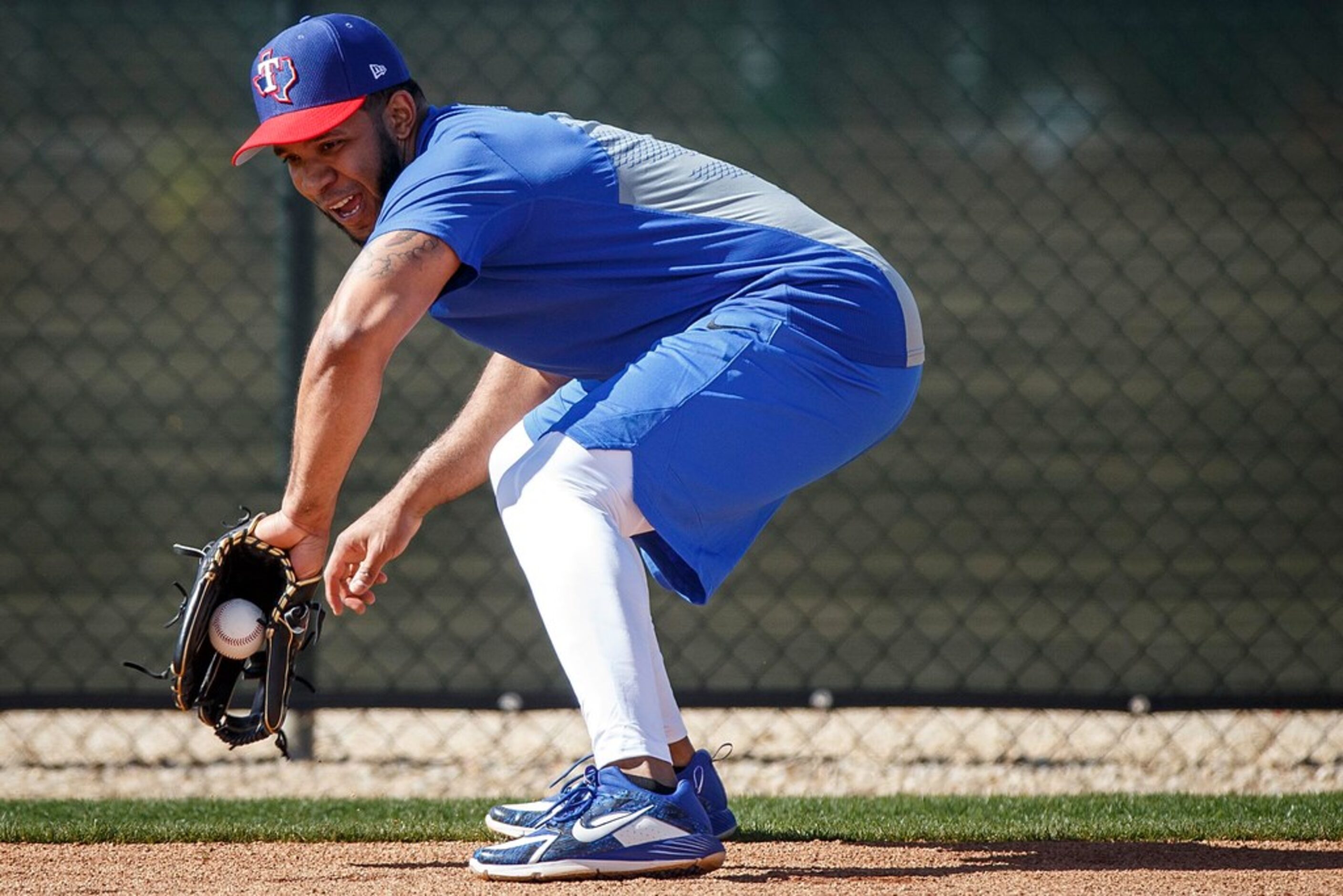 Texas Rangers shortstop Elvis Andrus takes infield practice during a spring training workout...