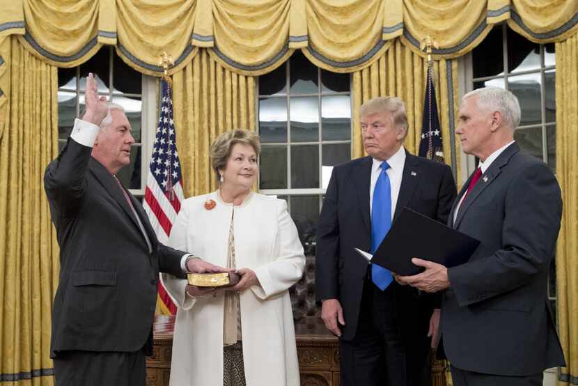 President Donald Trump watches as Rex Tillerson, accompanied by wife Renda St. Clair, is...