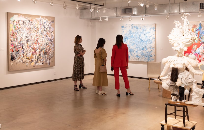 Guests look at a piece of artwork at the Dallas Art Fair.