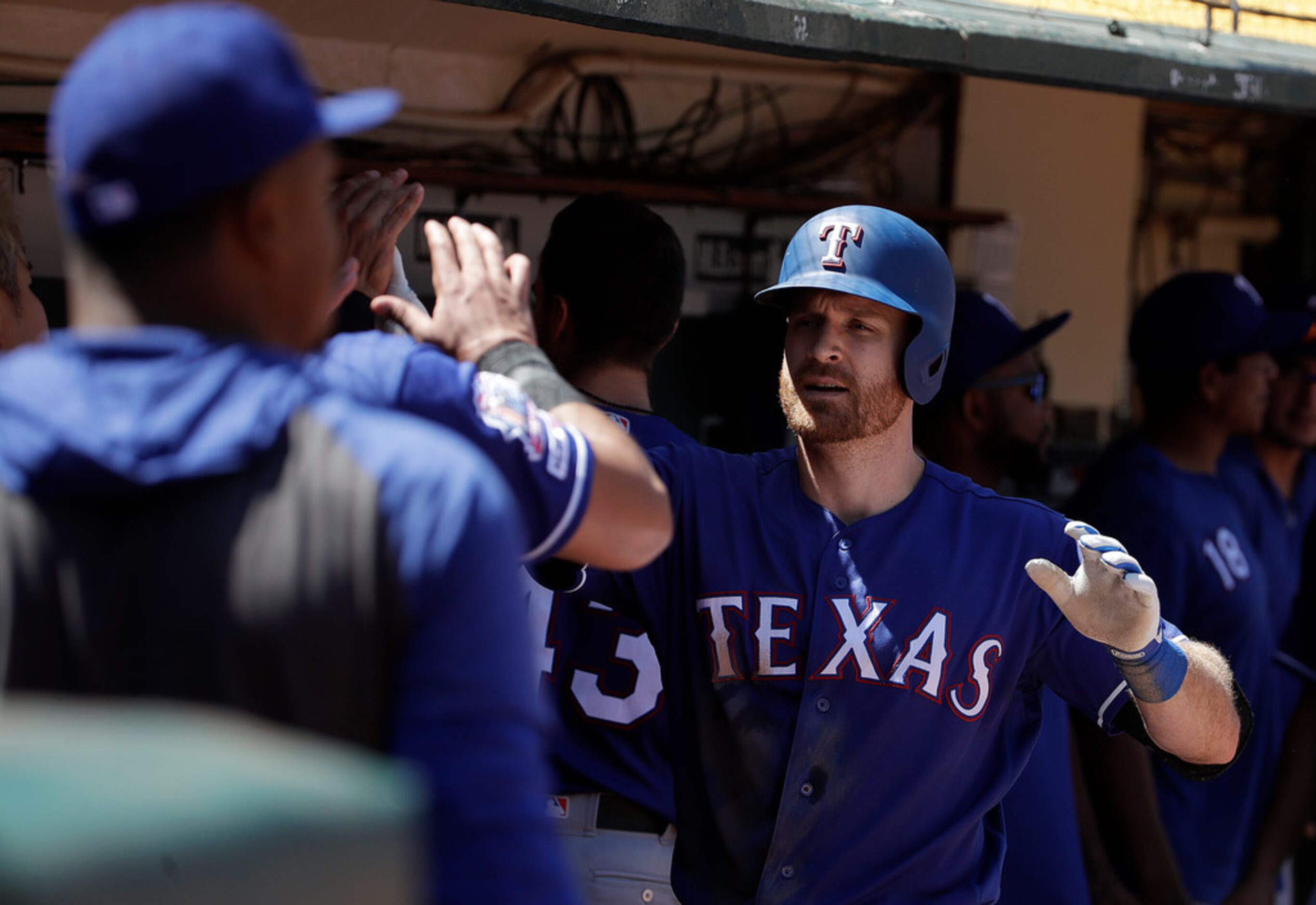 Texas Rangers' Logan Forsythe, right, is congratulated by teammates after hitting a solo...