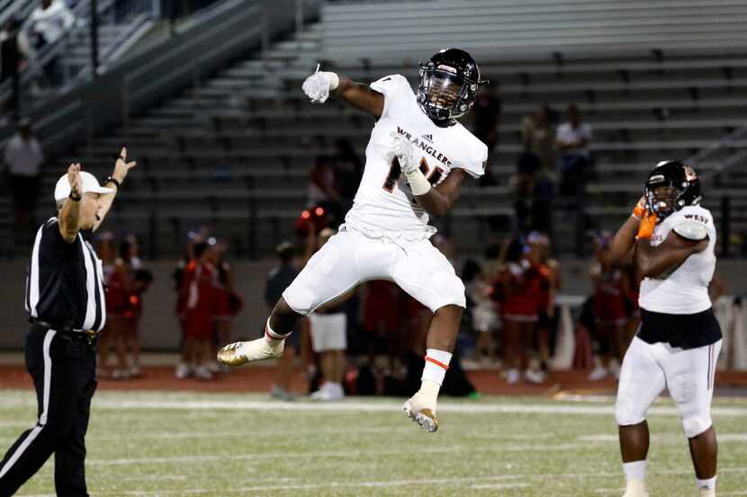 West Mesquite defender Derrian Forge (14) celebrates making the final tackle of the game...
