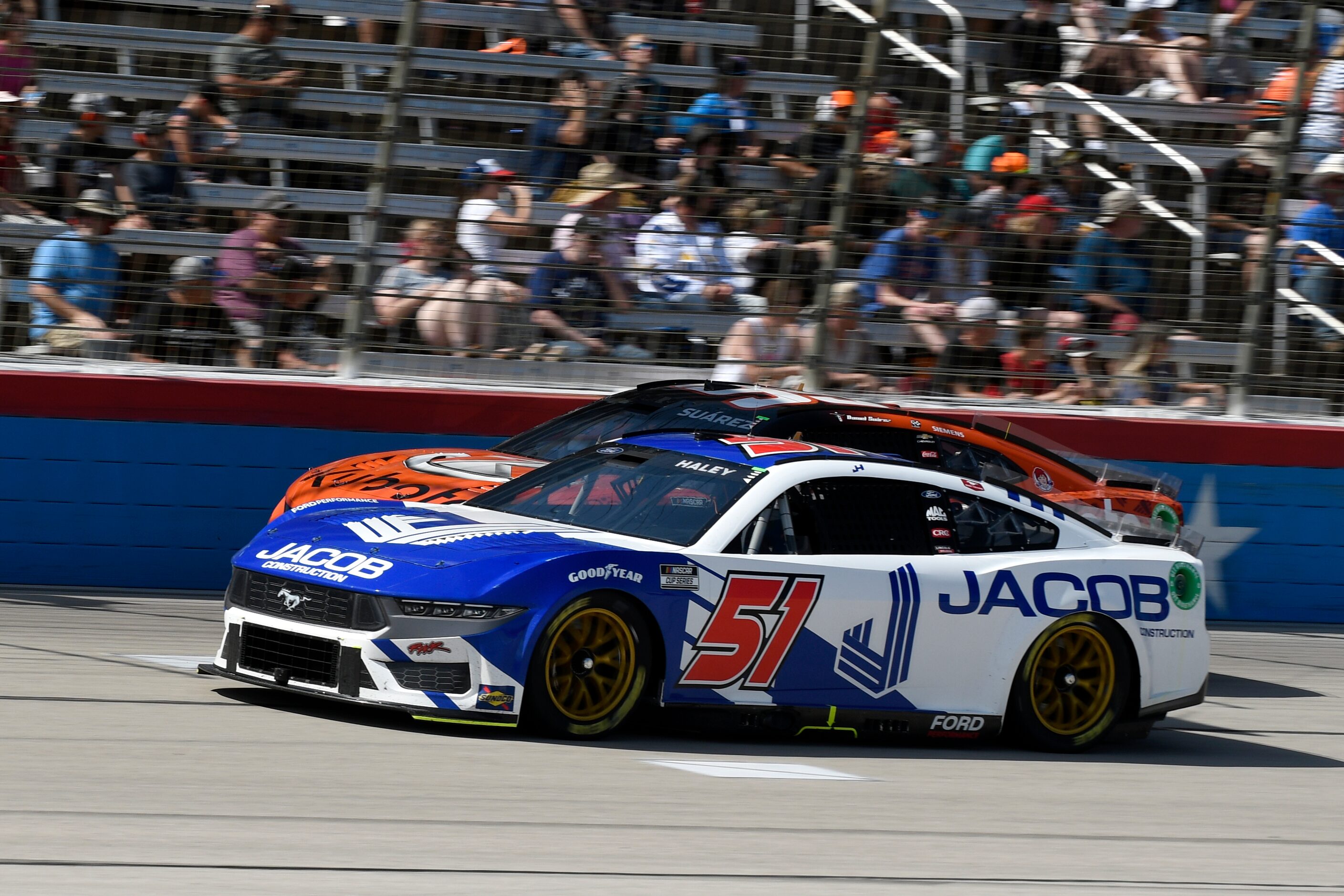 Justin Haley (51) leads Daniel Suarez, rear, out of Turn 4 during a NASCAR Cup Series auto...