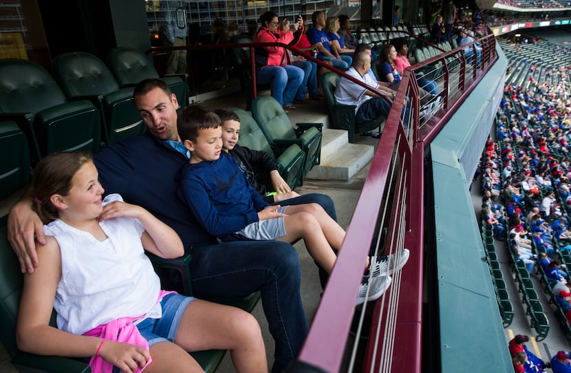 Former MLB pitcher Chris Young sits in a suite with his children, Cate Young, 11, Grant...