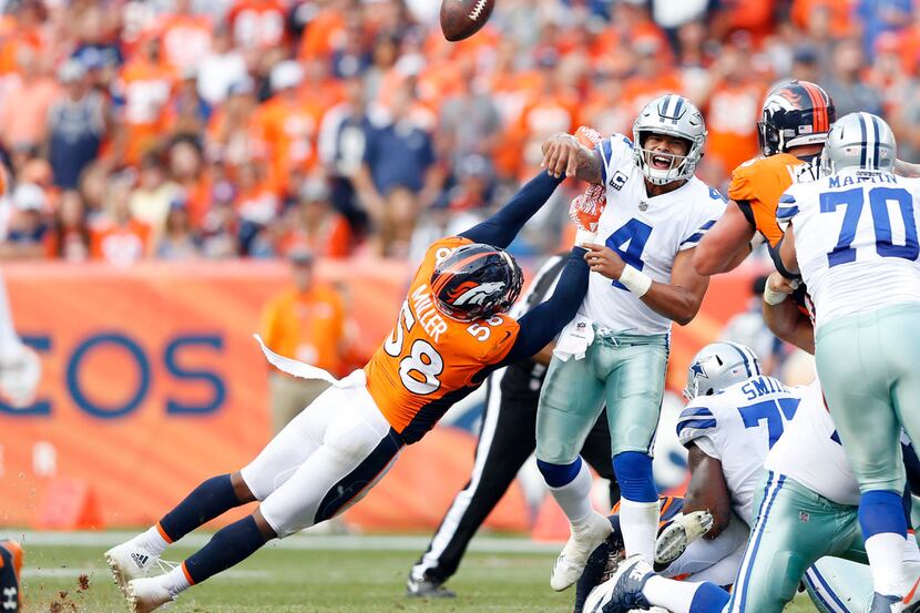 Denver Broncos outside linebacker Von Miller (58) disrupts a pass attempt by Dallas Cowboys...