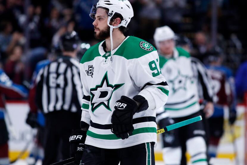 Dallas Stars center Tyler Seguin heads off the ice as members of the Colorado Avalanche...