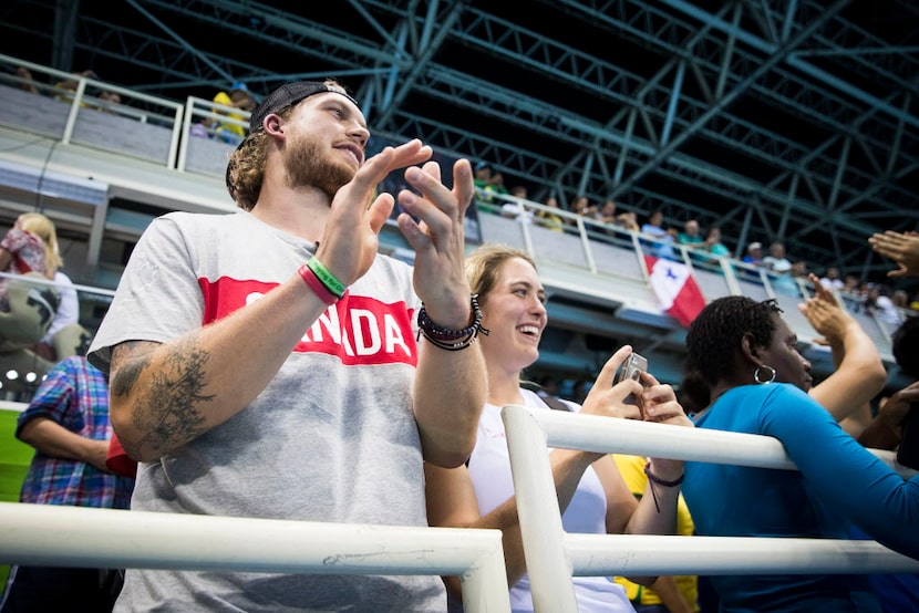 Dallas Stars defenseman Jamie Oleksiak cheers for his sister Penny Oleksiak of Canada after...