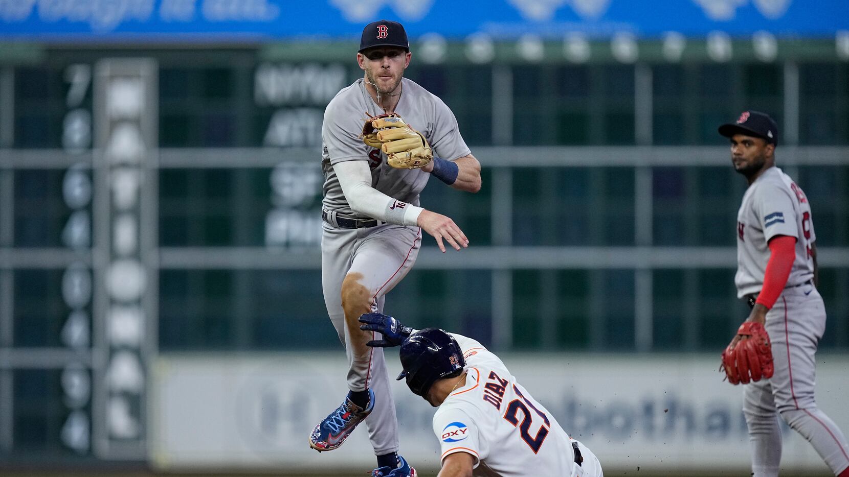 Boston Red Sox shortstop Trevor Story turns a double play on Houston Astros' Jeremy Pena...