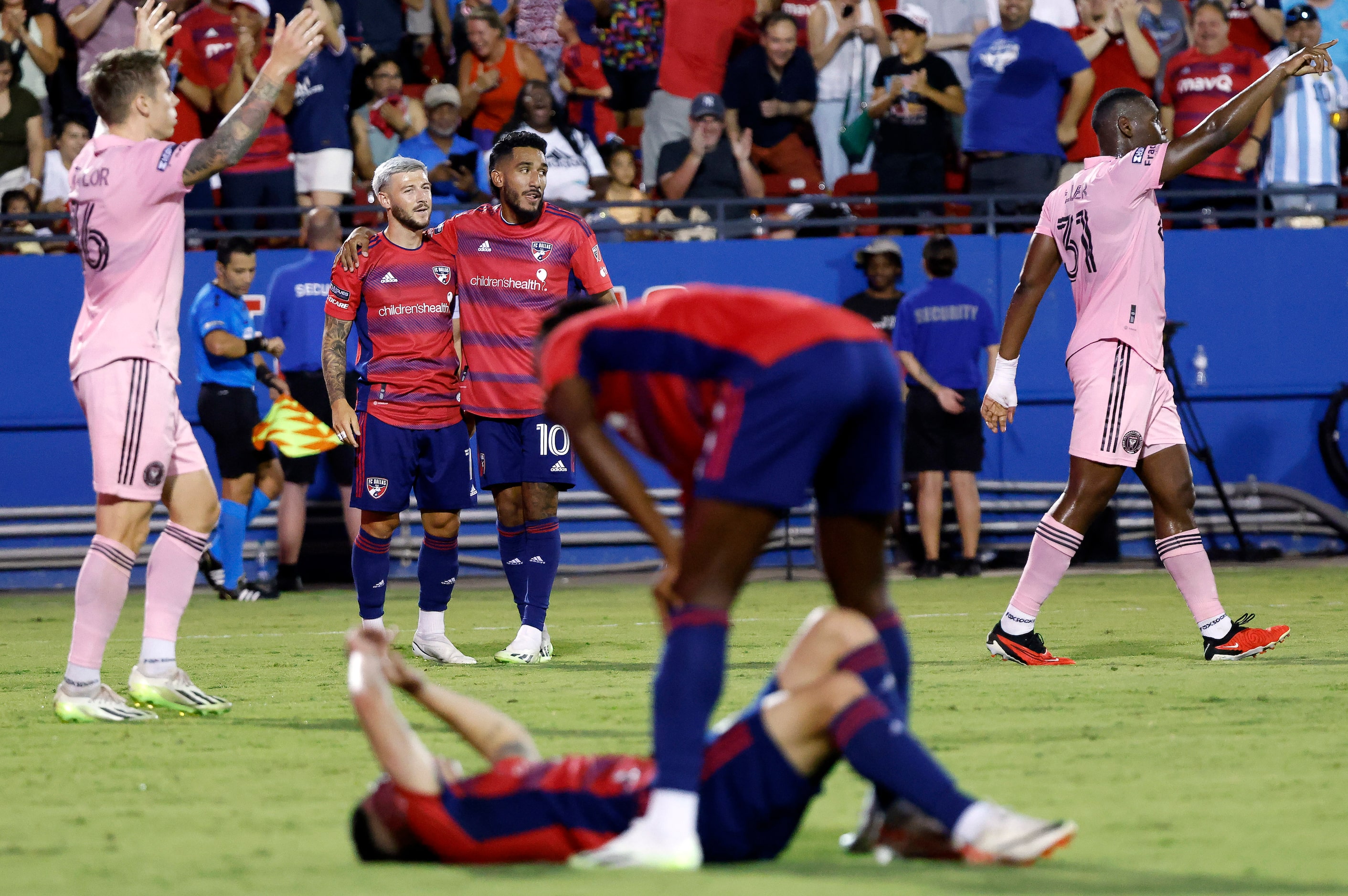 FC Dallas forward Paul Arriola (7) and FC Dallas forward Jesús Ferreira (10) hug after...