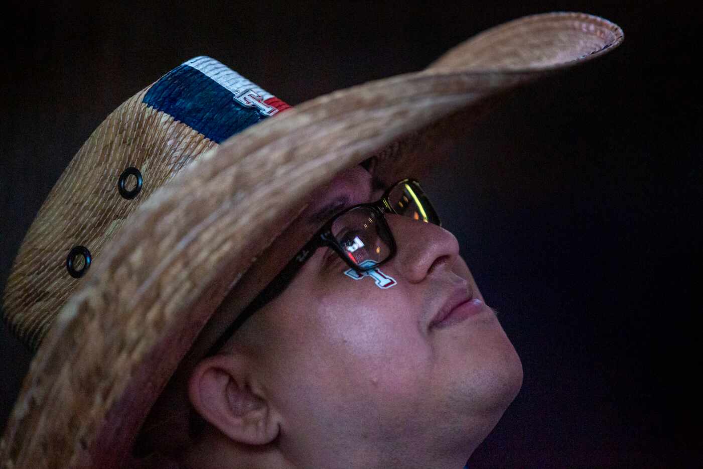 Mark Moreno, from Arlington, Texas, watches the opening day game of the Texas Rangers season...