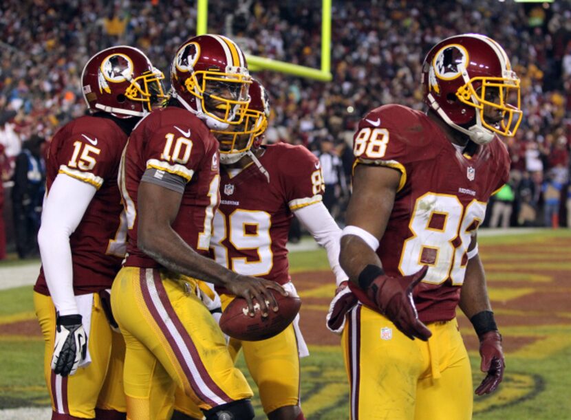 Washington Redskins quarterback Robert Griffin III (10) is all smiles after scoring a...