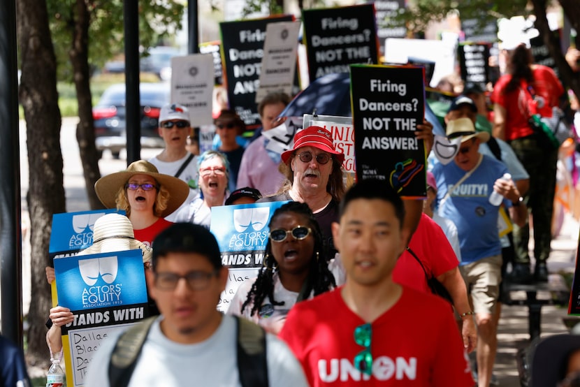 Union members, elected officials and allies from the community take part in a rally towards...