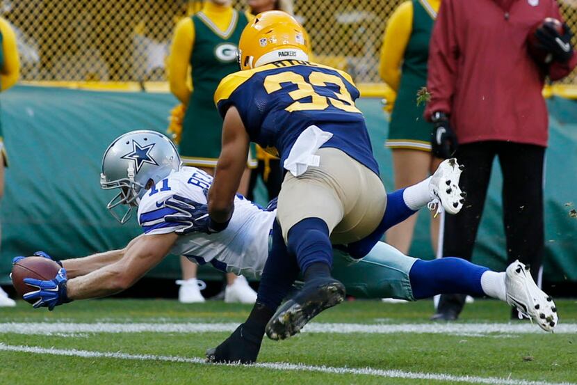 Dallas Cowboys wide receiver Cole Beasley (11) dives past Green Bay Packers strong safety...
