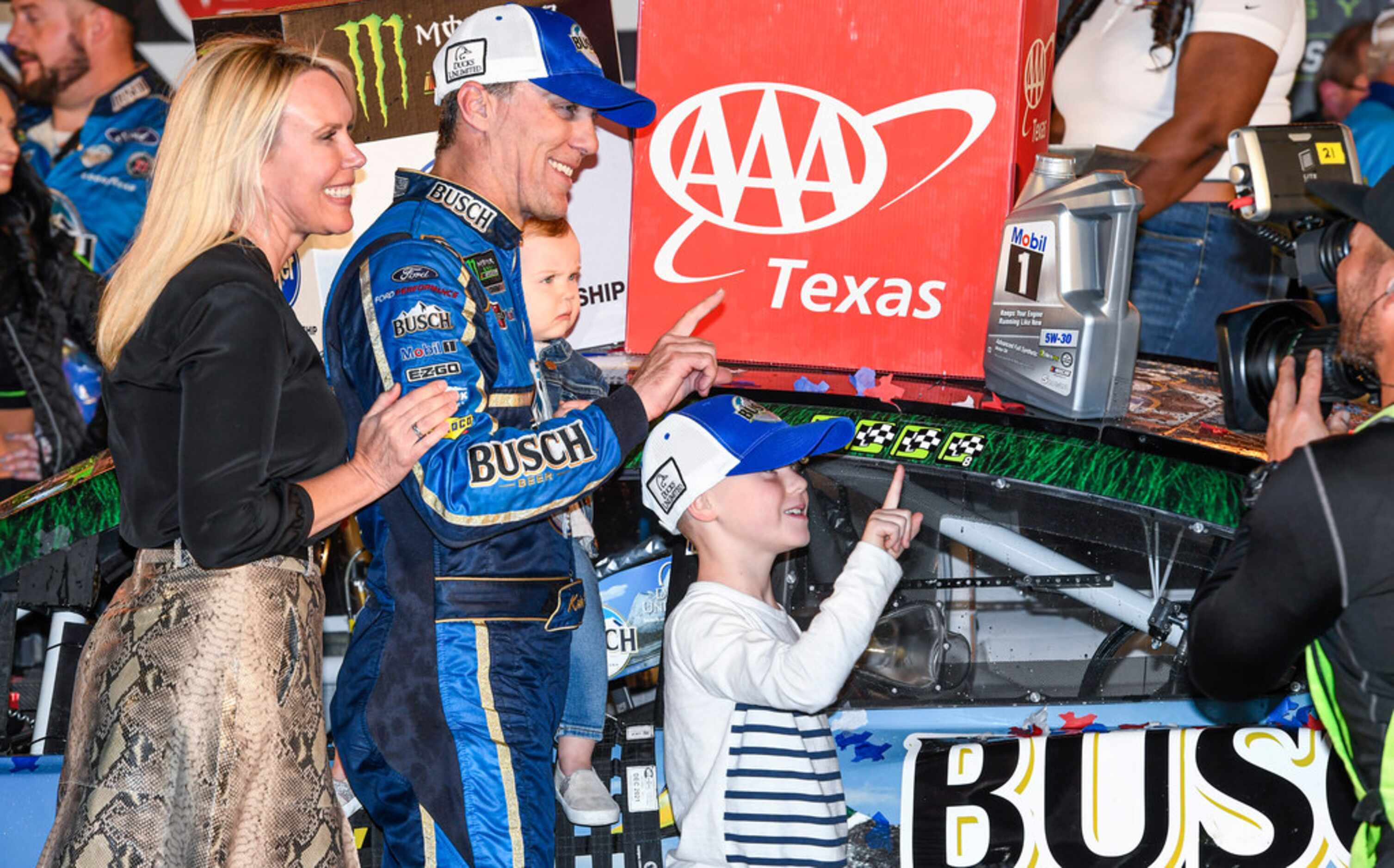 Kevin Harvick and his family celebrate in Victory Lane after winning a NASCAR Cup Series...