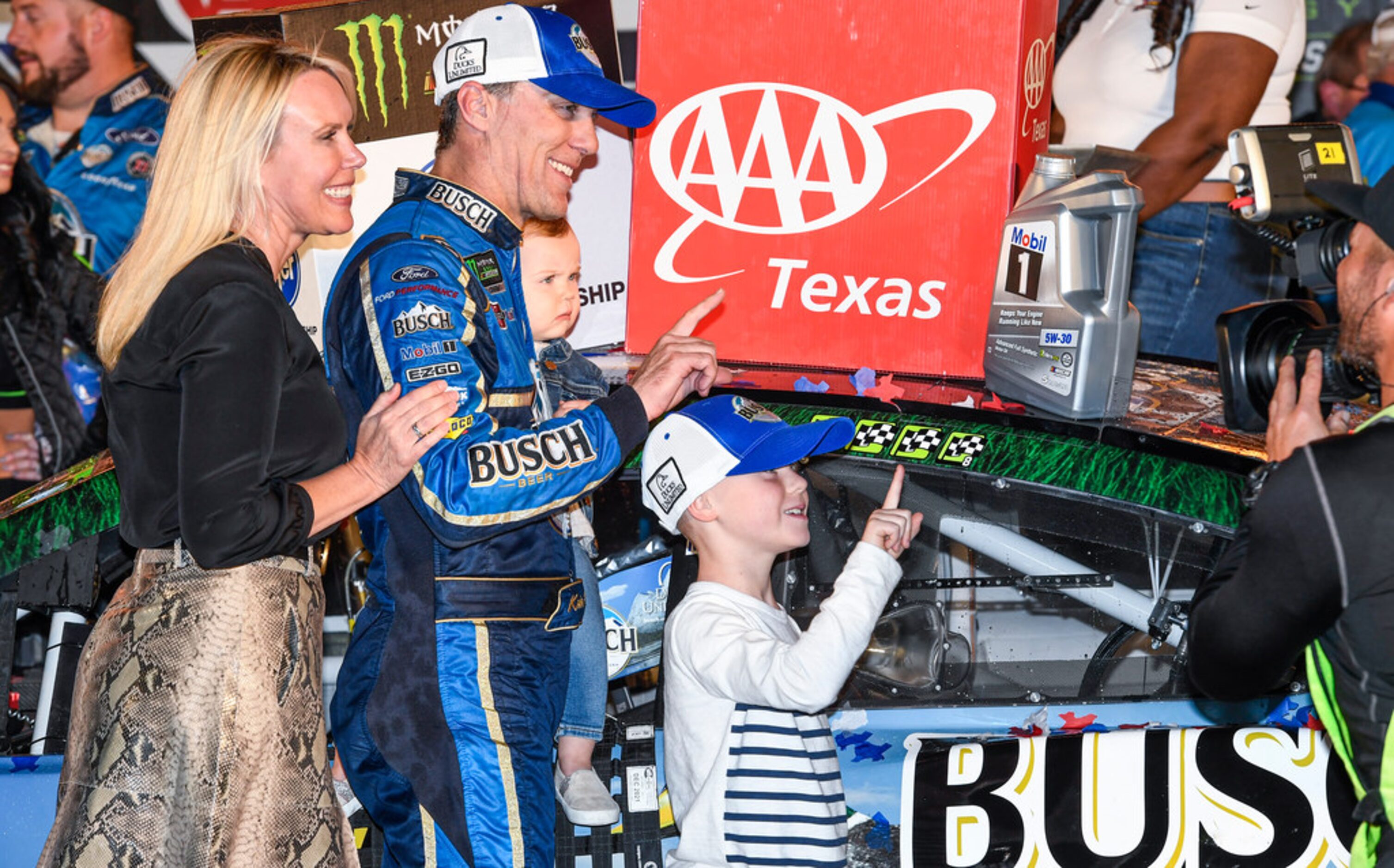 Kevin Harvick and his family celebrate in Victory Lane after winning a NASCAR Cup Series...